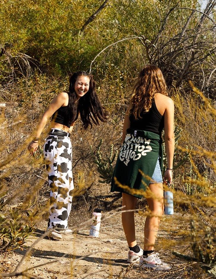 Two students take a walk in the Bernard Field Station.